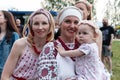 Minsk. Belarus. 08.12.2022. Beautiful smiling women in national Slavic Belarusian ethnic costumes with a baby in her arms. Feast