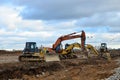 Bulldozer Shantui SD16 and Group Excavators brands of the Kraneks and CATERPILLAR with buckets on a