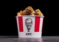 Minsk, Belarus - December 03, 2021: black background, night. Lots of hot wings or strips of KFC chicken in a KFC Kentucky Fried Royalty Free Stock Photo