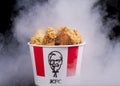 Minsk, Belarus - December 03, 2021: black background, night. Lots of hot wings or strips of KFC chicken in a KFC Kentucky Fried Royalty Free Stock Photo