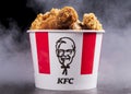 Minsk, Belarus - December 03, 2021: black background, night. Lots of hot wings or strips of KFC chicken in a KFC Kentucky Fried Royalty Free Stock Photo