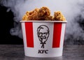 Minsk, Belarus - December 03, 2021: black background, night. Lots of hot wings or strips of KFC chicken in a KFC Kentucky Fried Royalty Free Stock Photo