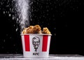 Minsk, Belarus - December 03, 2021: black background, night. Lots of hot wings or strips of KFC chicken in a KFC Kentucky Fried Royalty Free Stock Photo