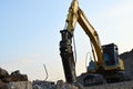 Excavator New Holland E215B with hydraulic breaker hammer for the destruction of concrete
