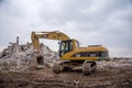 Excavator CATERPILLAR 325CL at demolition of tall building. Hydraulic machine for demolish. Backhoe