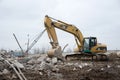 Excavator CATERPILLAR 325CL at demolition of tall building. Hydraulic machine for demolish. Backhoe