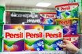 MINSK, BELARUS - February 2, 2020: A buyer takes Persil washing powder from a supermarket shelf. Woman purchases washing powder at