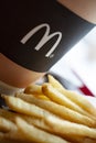 Minsk, Belarus, February 18, 2018: Paper cup of coffee with McDonald`s logo close-up and French fries in McDonald`s Restaurant