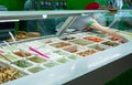 Minsk, Belarus - iune 17, 2017: A cook prepares a dish with assorted of ingredients in a restaurant `Salateira`