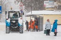 Group of street cleaners in uniform waiting for a tractor