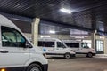 MINSK, BELARUS - JANUARY 2020: rows of new white minibuses and vans on parking