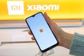 MINSK, BELARUS - January 29, 2020: Smartphone with Xiaomi Logo on screen in hand. Customer choosing smartphone in mobile phones Xi