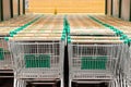 Minsk, Belarus - July 16, 2019: Green supermarket trolleys. Front view of two rows of empty shopping carts shopping