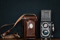 Vintage Rolleiflex f2.8, Twin Lens on black background. Retro medium format camera. Film camera for 120 mm film wiht brown leather