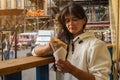 Minsk, Belarus - 10 July, 2022. woman eating Belgian french fries with sauce at food court. street food festival Royalty Free Stock Photo