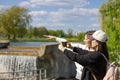 Minsk, Belarus, June 23, 2020: Asian and European girls in the green summer park observing the landscape Royalty Free Stock Photo