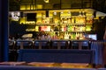 Minsk, Belarus June 22, 2022: A bar counter in a restaurant with low lighting. Bottles of expensive alcohol are on the shelves in Royalty Free Stock Photo