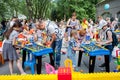 Minsk, Belarus, June 3, 2018: Children with parents play table football and other games on playground with a lot of toys in city o