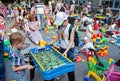 Minsk, Belarus, June 3, 2018: Children play table football on playground with a lot of children, parents and toys in city outdoors