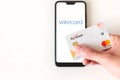 Minsk, Belarus- June 27 2020: Payoneer card and smartphone with wirecard logo on the screen. Payoneer funds were recently put on Royalty Free Stock Photo