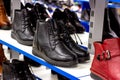 MINSK, BELARUS - MARCH 22, 2021: Black woman autumn boots with shoelaces on retail shoes shop display shelf. Royalty Free Stock Photo