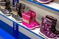 MINSK, BELARUS - MARCH 22, 2021: Colorful waterproof winter kid boots on retail shoes shop display shelf.