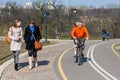 Minsk, Belarus - March 23, 2014: A man with a cat on his shoulders rides a bicycle. Pets on the original walk