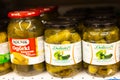 Pickles of cucumbers in banks on the shelves in the store