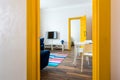 MINSK, BELARUS - March, 2019: retro bright interior of hipster flat apartments with blue sofa, yellow door and colored carpet Royalty Free Stock Photo