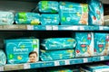 Minsk, Belarus, March 13, 2019: Shelves with diapers under the brand `Pampers` of baby diapers for sale in supermarket.