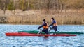 MINSK, BELARUS - MARCH 09, 2022: Two young rowing canoeists trains in open water early spring