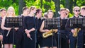 Brass band in park. Young musicians, music school students