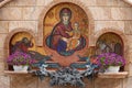 Minsk, Belarus. - May, 2019. Close-up of fountain with flowers and mosaical image of Mary Virgin with Jesus Christ Royalty Free Stock Photo