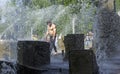 Minsk, Belarus - May 9, 2018 Handsome man with a naked torso in the fountain. Splashes, good mood. Victory Day .