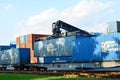 Loading shipping containers by richtracker on the freight rail car at Transport-Logistics Centre