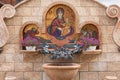 Minsk, Belarus. - May, 2019. Fountain with flowers and mosaical image of Mary Virgin with Jesus Christ Royalty Free Stock Photo