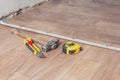 Minsk, Belarus - November 12, 2018: installing self-adhesive plastic floor threshold sill by MYCK docking floor cov