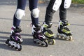 Minsk, Belarus, October 20, 2019. Children`s legs with protection and in roller skates. Boy and girl rollerblading