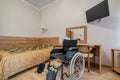 MINSK, BELARUS - OCTOBER 2020: Interior of the bedroom with wheelchair in apartments or hotel for people with disabilities,