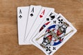 Poker full house playing card, wooden background Royalty Free Stock Photo