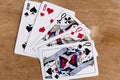 Poker full house playing card, wooden background Royalty Free Stock Photo