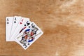 Poker full house playing card, wooden background, copy space Royalty Free Stock Photo