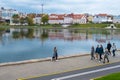 Young people walk along the promenade of Svisloch river in Old Part Nyamiha of Minsk, Belarus Royalty Free Stock Photo
