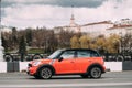 Minsk, Belarus. Orange Color Mini Cooper All 4 Car With Woman Dr