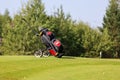 Minsk. Belarus - 25.07.2021 - Push-Pull Golf Carts. Green grass, trees.