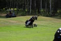 Minsk. Belarus - 24.07.2021 - Push-Pull Golf Carts. Green grass, trees.