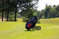 Minsk. Belarus - 25.07.2021 - Push-Pull Golf Carts. Green grass, trees.