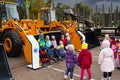 Minsk, Belarus, September 20, 2022: Children pose in a forklift bucket, a new forklift is on display