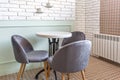 Comfortable armchairs with with white brick wall in cafe Royalty Free Stock Photo