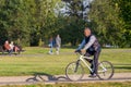 People relaxing in the city park, Riding bikes, walking, sitting on a bench